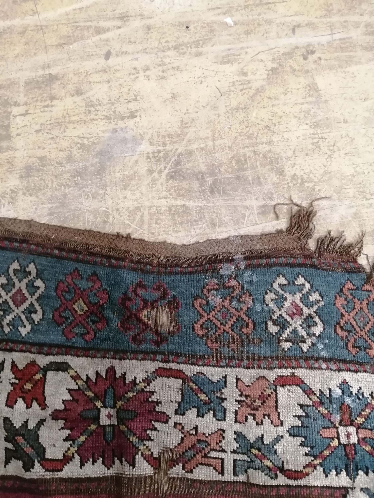 An antique Kazak rug, 310 x 150cm